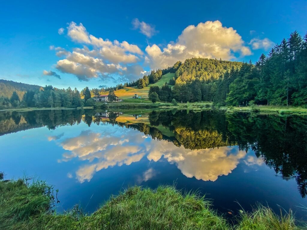 Beautiful clouds reflection in water of Lispach lake in the La Bresse, Vosges